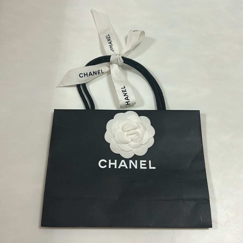 Small Black Chanel Shopping Bag with Camellia Embellishments and Logo Ribbon